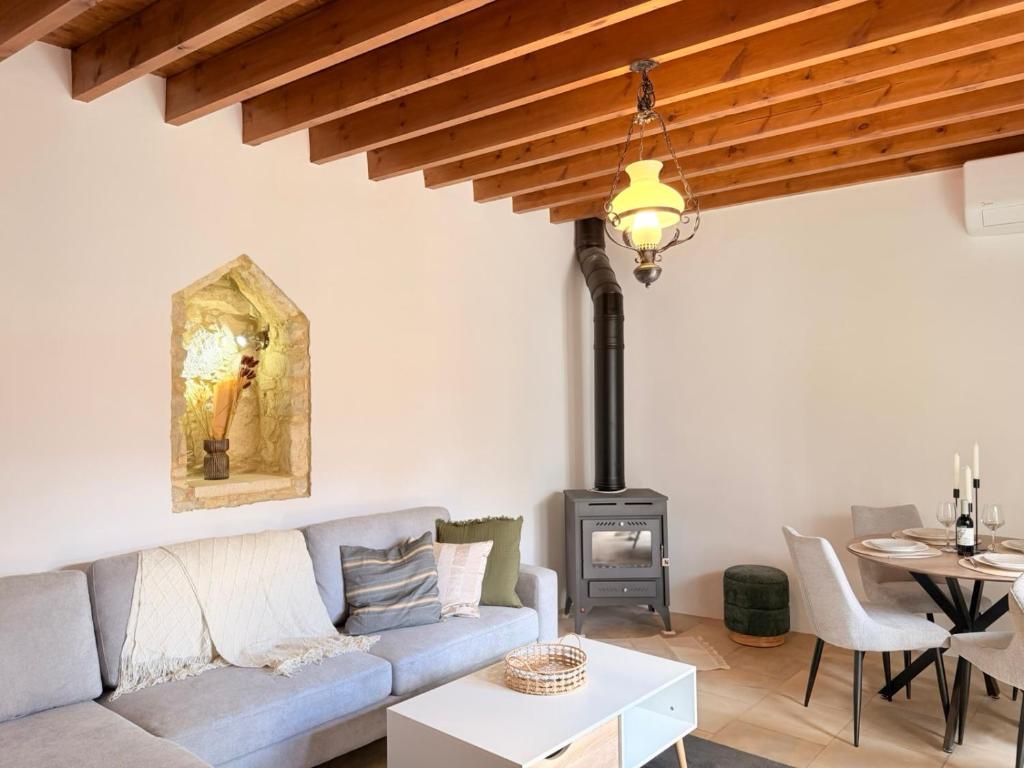 a living room with a couch and a wood stove at Estia Vouni Boutique Houses in Vouni