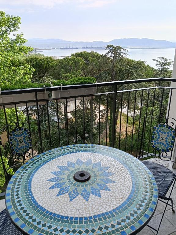 a table on a balcony with a view of the ocean at Casa Sofia in Marina Julia