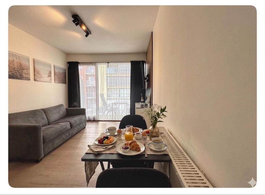 a living room with a table with food on it at Studio Palace 217 in Middelkerke