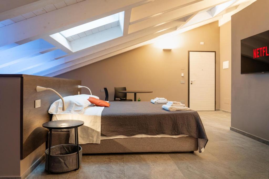 a bedroom with a bed and a skylight at Villa Eliseo Luxury Suites in Modena