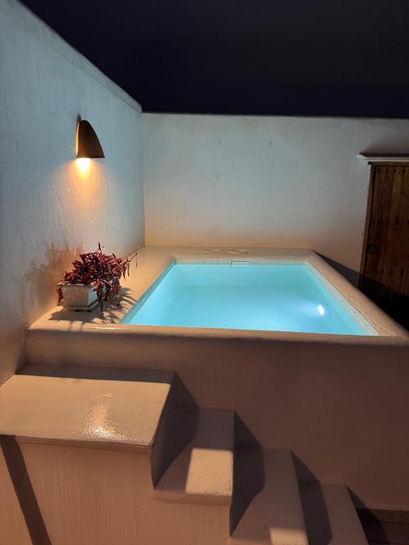 a large swimming pool in a room with a light at Céntrico duplex con piscina in Jávea