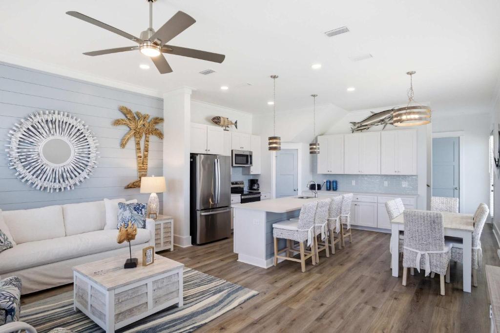 a living room and kitchen with a couch and a table at Perfect location Pool 4 bedroom SGI Pet in Eastpoint