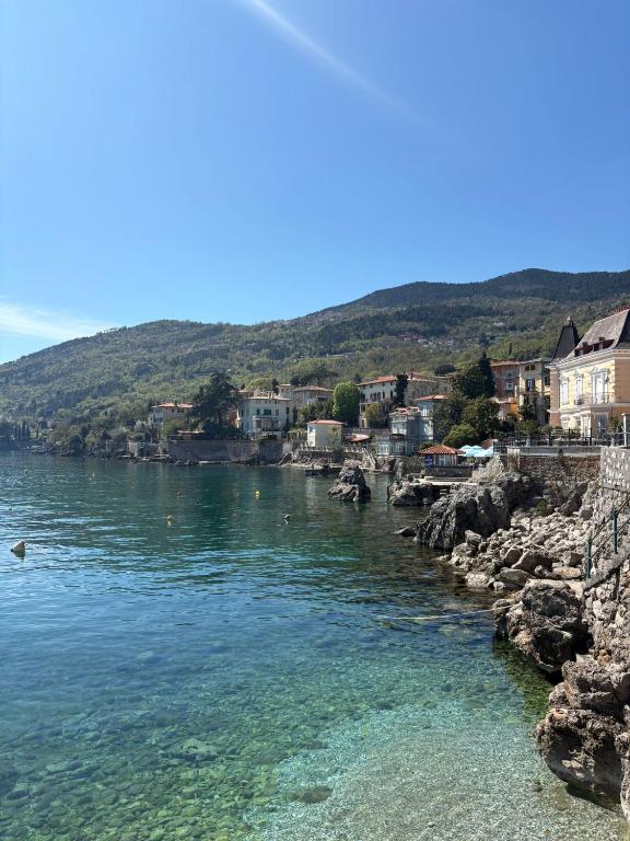 a view of a body of water with houses at Guest house Ivo in Lovran