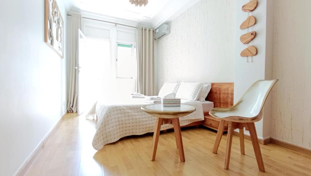 a bedroom with a bed and a table and a chair at Rami Home in Casablanca