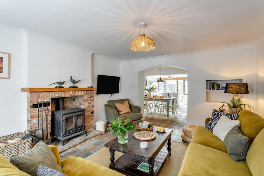 a living room with a couch and a fireplace at 4 Bed in Masham oc-w32087 in Masham