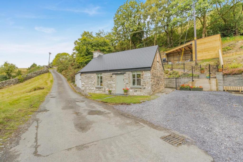 a stone house on the side of a road at 2 Bed in Cwmystwyth oc-p32779 in Pentre-briwnant