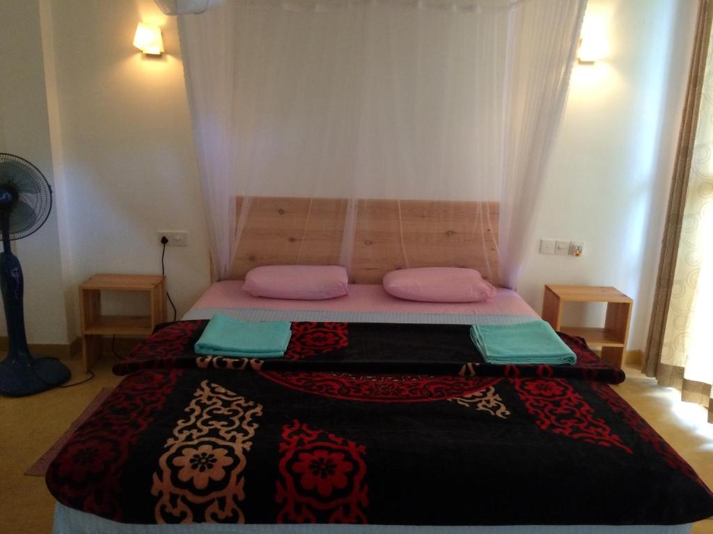 Postel nebo postele na pokoji v ubytování Raveena Guest House