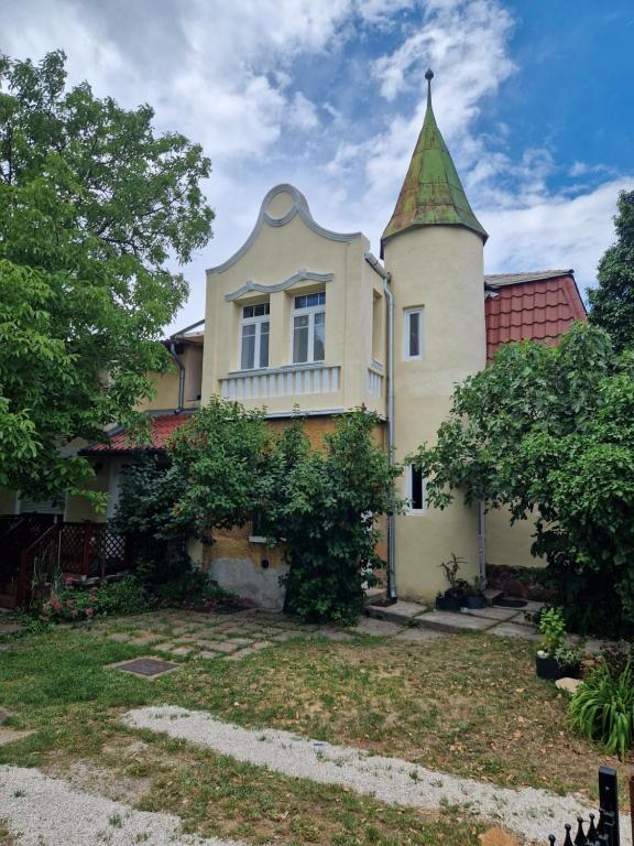 an old house with a tower on top of it at History Tornyos Apartman in Balatonfüred