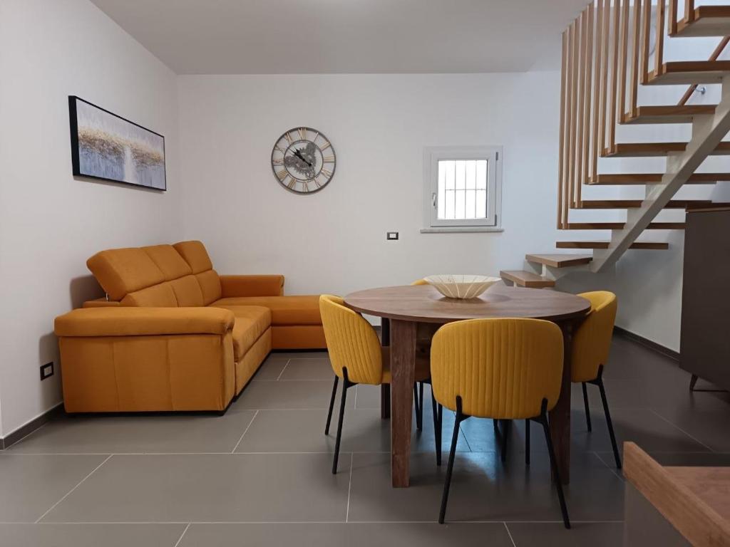 a living room with a table and chairs and a couch at B&B Belvedere in Monreale