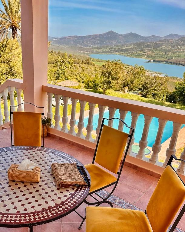 a table and chairs on a balcony with a view at Dar Bakkali Nadi in Tangier