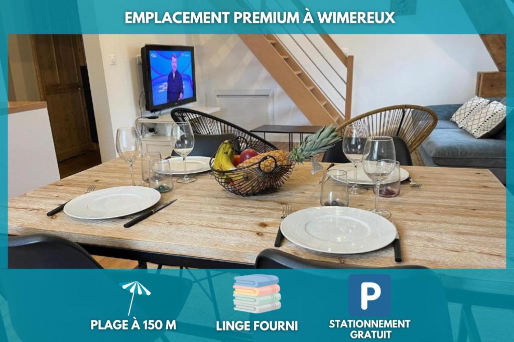 a wooden table with a bowl of fruit and wine glasses at L'Universel, 3 ch calme et cosy près de la plage in Wimereux