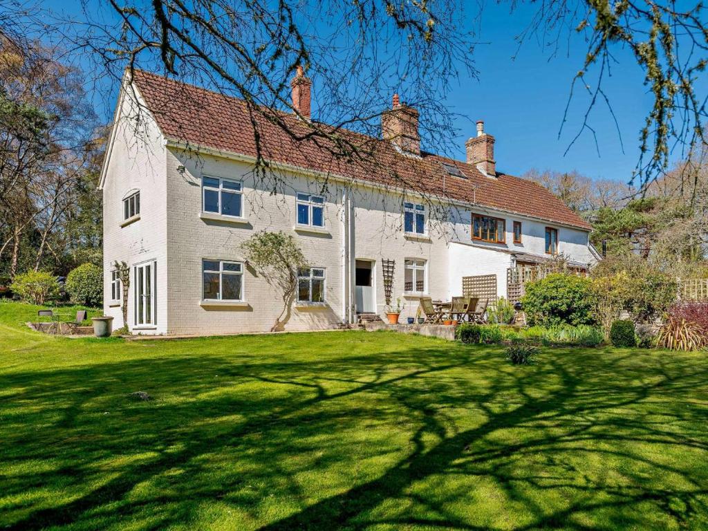 a large white house with a green yard at 4 Bed in Wareham oc-dc204 in East Stoke