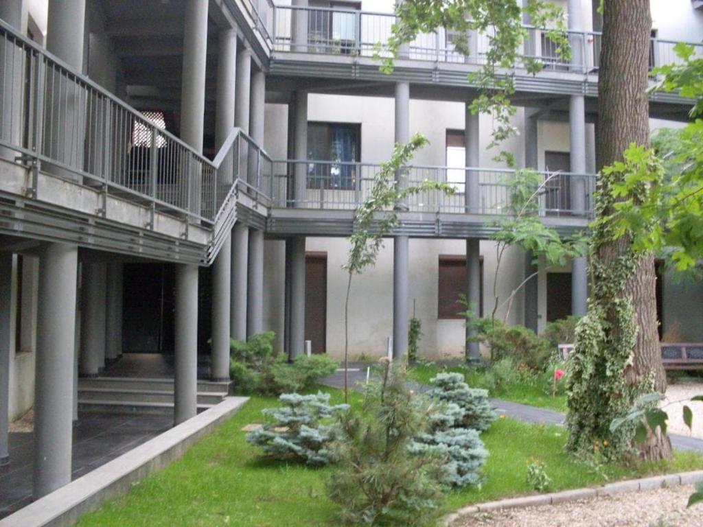 an external view of an apartment building with a garden at Bosco Dream Neptun-Olimp in Neptun