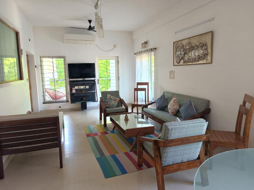 a living room with a couch and a table at Mel Ville in Pondicherry