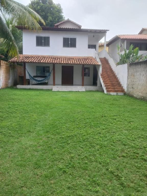a house with a lawn in front of it at casa pescador centro in Porto Seguro