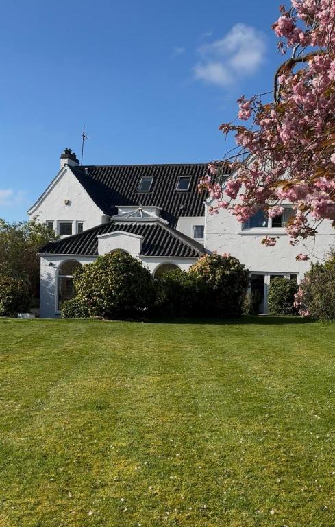 a large white house with a large yard at CarMichael in Edinburgh