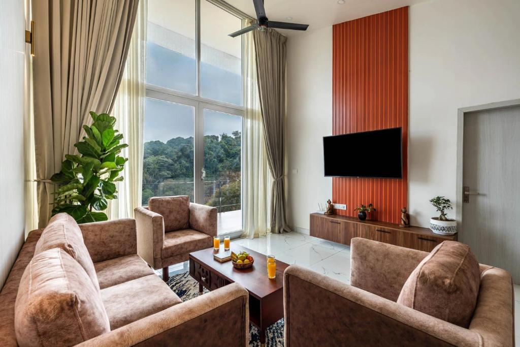 a living room with two couches and a television at Vaga Valley in Vagamon