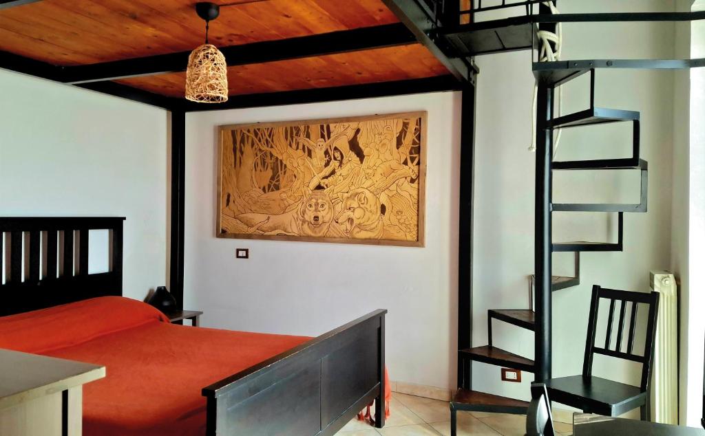 a bedroom with a bed and a ladder and a television at Maison Morgana in Formia