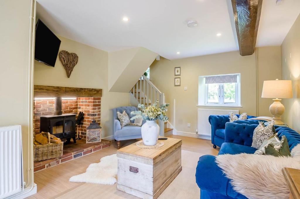 a living room with blue couches and a fireplace at 2 Bed in Hanworth oc-h32041 in Hanworth