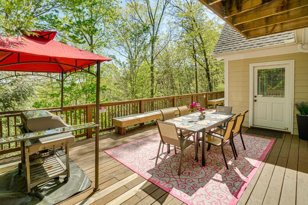a deck with a table and chairs and a bench at Luxe Helen Gem w/Hot Tub + Pool Access in Helen