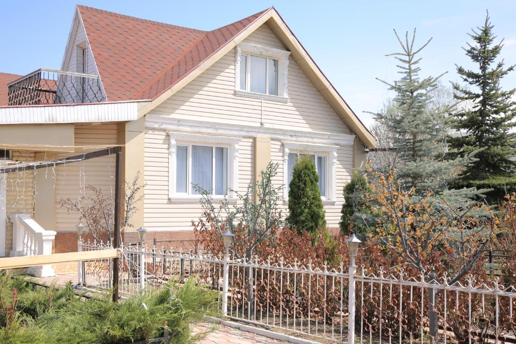 a house with a fence in front of it at Karakol Riviera in Karakol