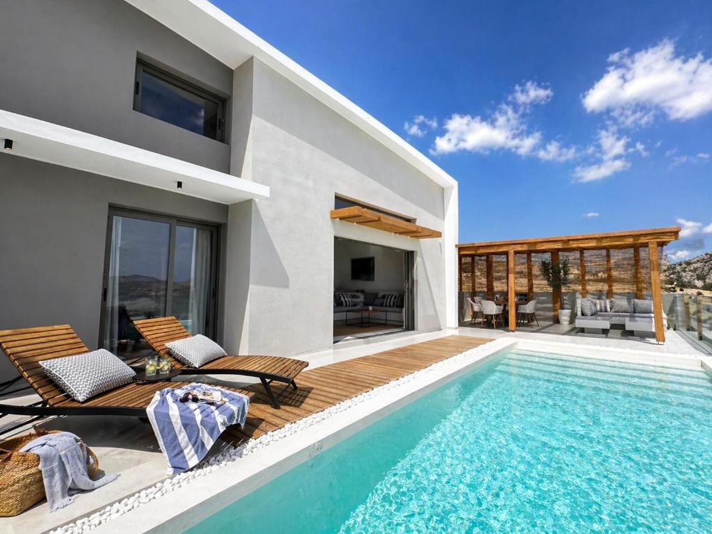a villa with a swimming pool and a house at Villa Irene Tolo in Tolo