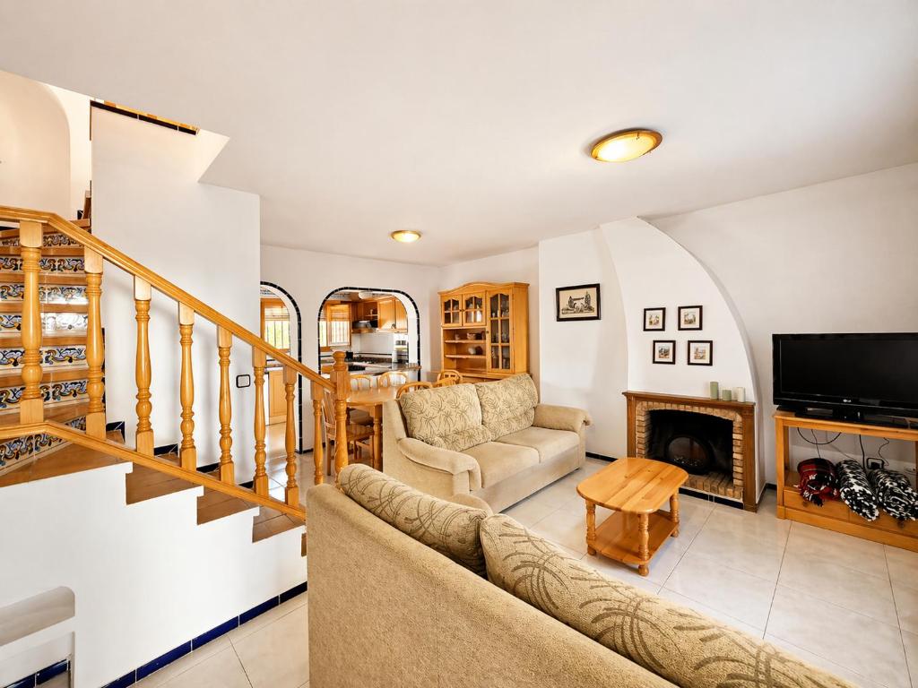 a living room with a couch and a fireplace at Stay in Costa Hispania in Santa Pola