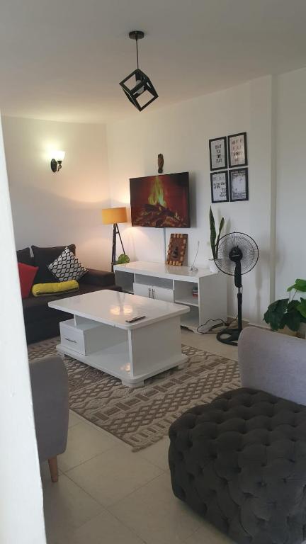 a living room with a couch and a coffee table at Bay Loft 1 Br Netflix Lake Views, Starlink in Homa Bay