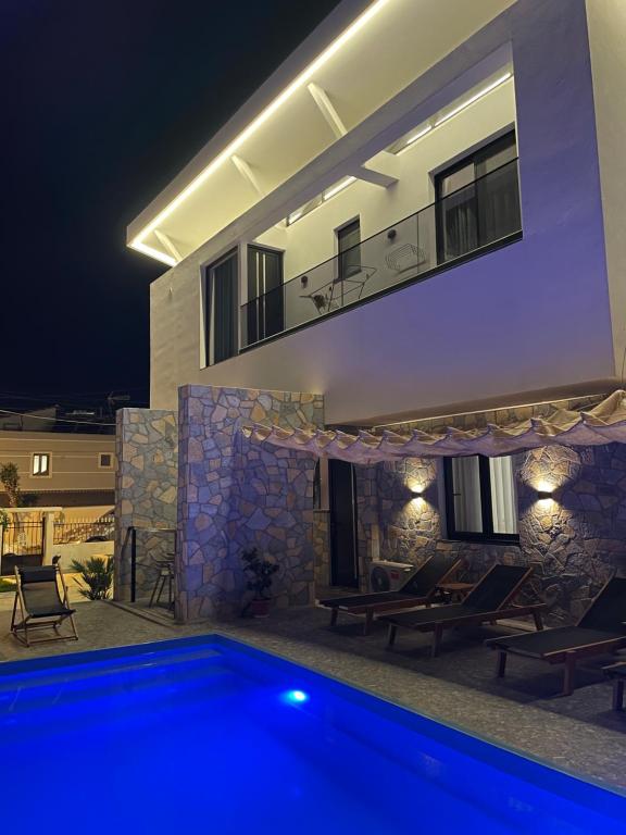a villa with a swimming pool at night at Villa Kociu in Ksamil