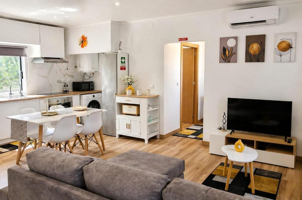 a living room with a couch and a table at Vila de Baixo in Lajes das Flores