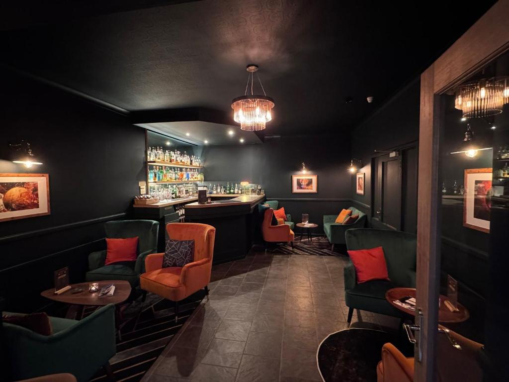 a restaurant with a bar with chairs and tables at Beinn Bhracaigh in Pitlochry