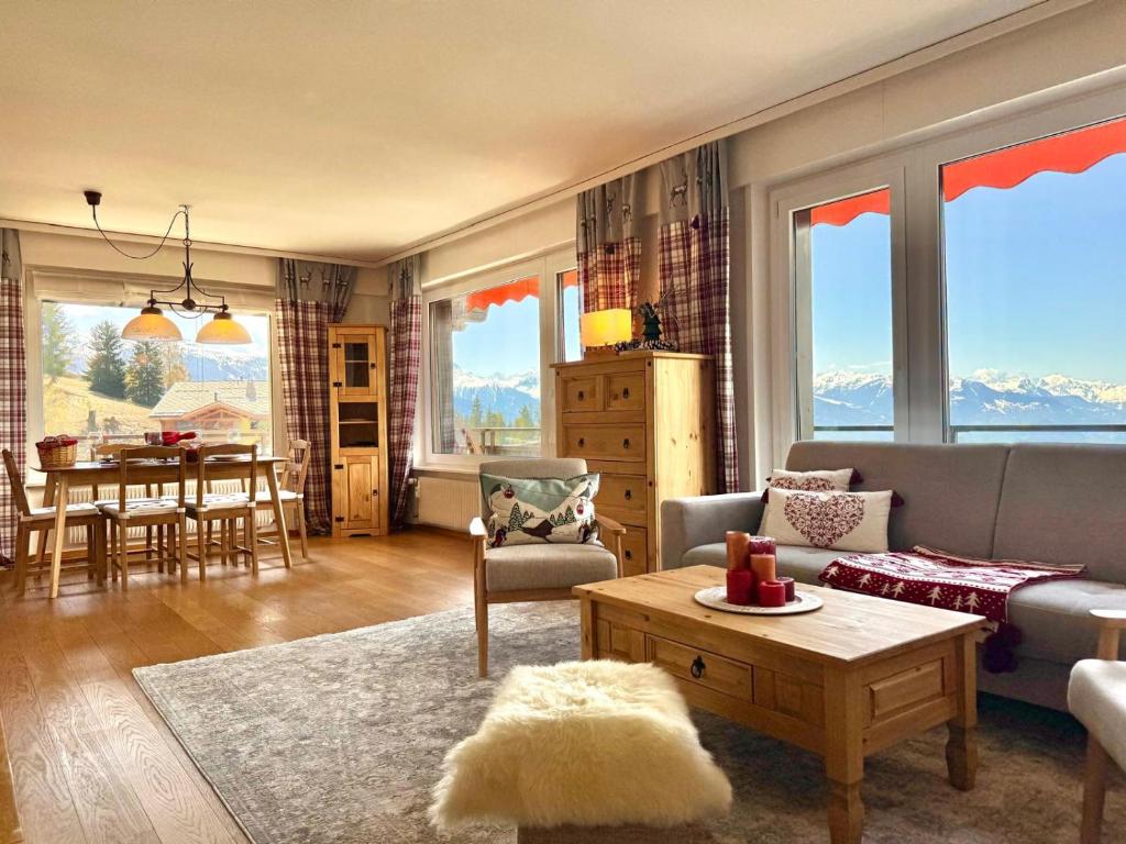 a living room with a couch and a table at Sunny Alpine Apartment - 180 View in Lens