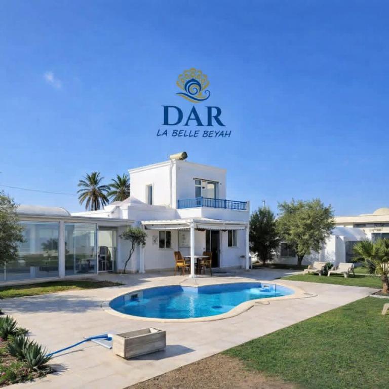 a large white house with a swimming pool in front of it at Villa Dar La Belle Beyah - Tezdaine in Taguermess