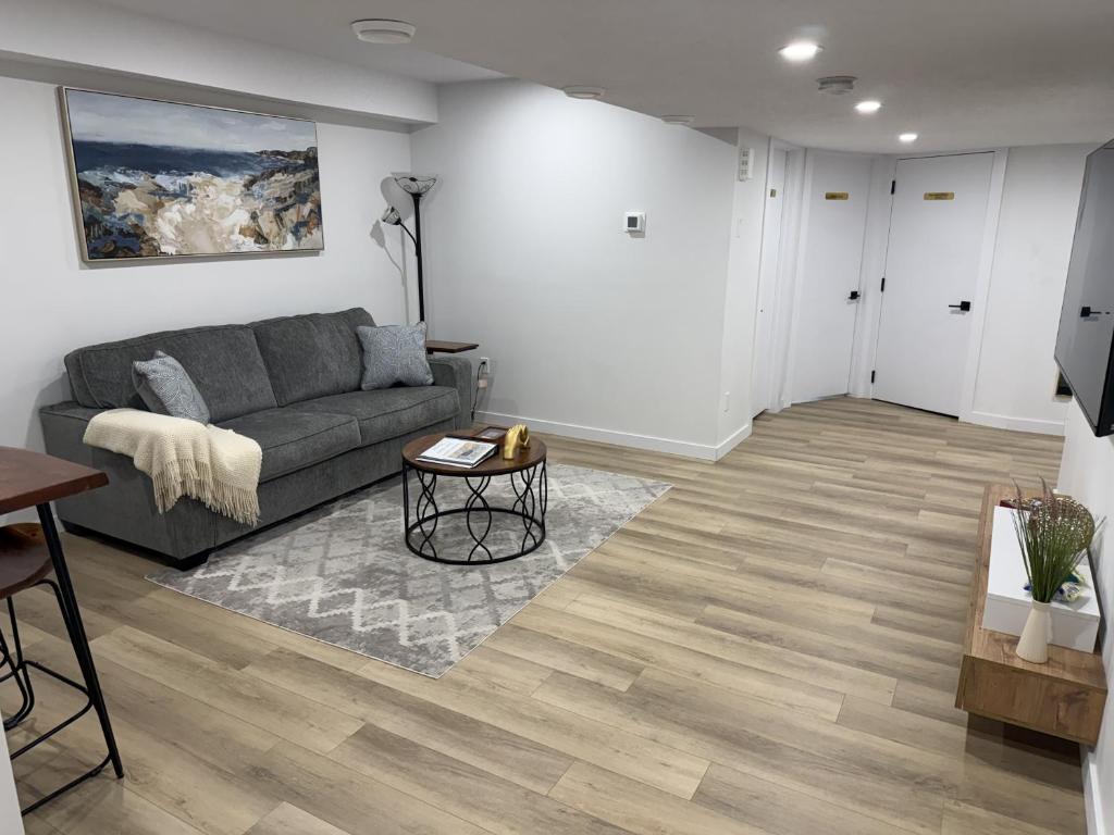 a living room with a couch and a table at Vinash Luxury Suite in Edmonton