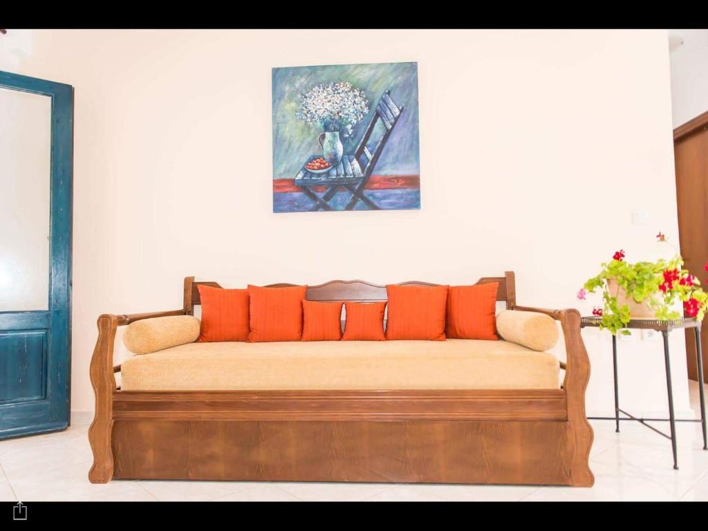 a couch in a room with a painting on the wall at Archipelagos Apartments in Arkasa