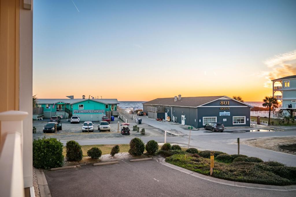 a view of a parking lot with cars in a parking lot at Salty Girl by Oak Island Accommodations in Oak Island