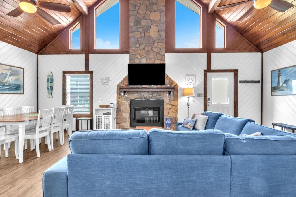 a living room with a blue couch and a fireplace at Salty Dawg by Oak Island Accommodations in Oak Island