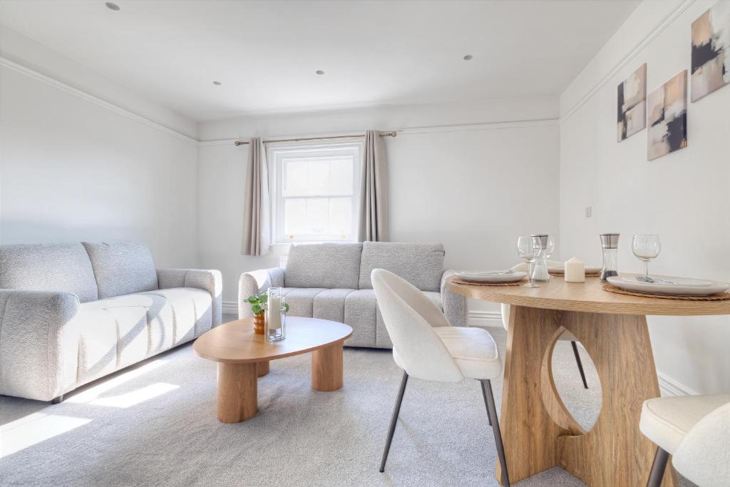 a living room with a couch and a table at 7 Clarendon Place in Maidstone