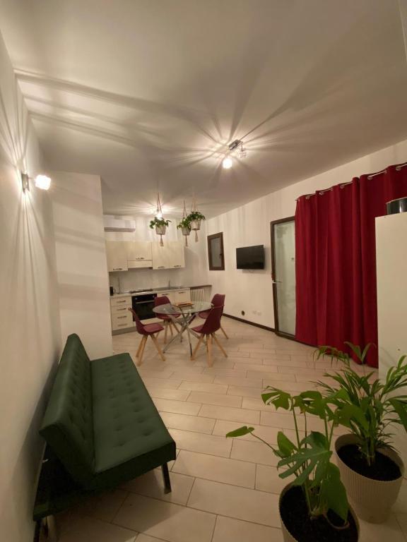 a living room with a couch and a table and chairs at Borghaus Iseo in Iseo