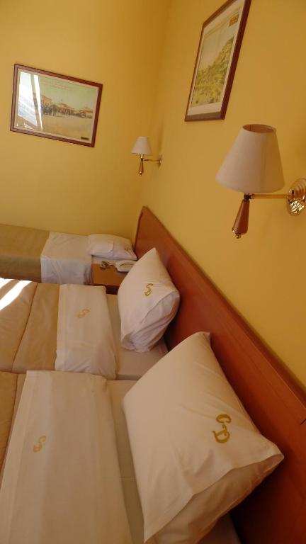 Postel nebo postele na pokoji v ubytování Cavo D' Oro