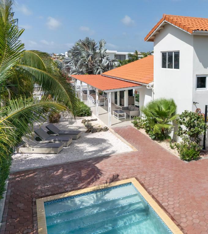 a view of a resort with a swimming pool at Tropical villa Curoyal near the beach in Jan Thiel