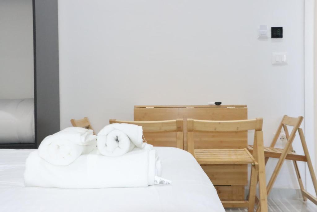 two towels sitting on top of a bed at Aura boutique hotel in Vlorë