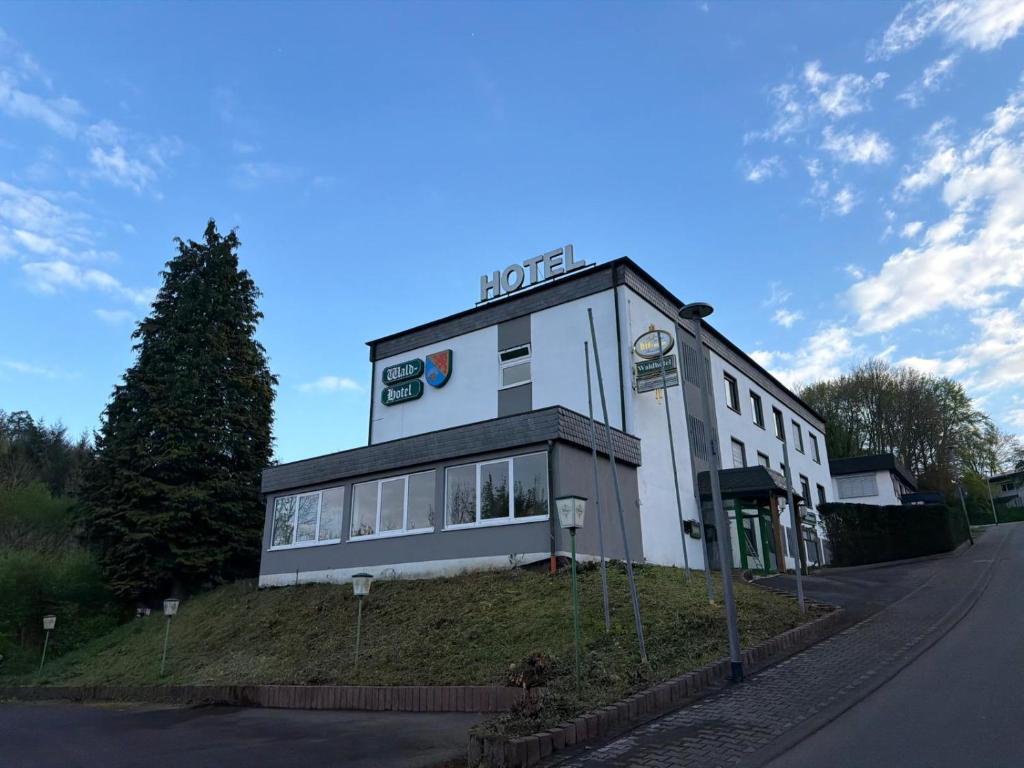 a building on the side of a street at Wald Hotel in Kirschweiler