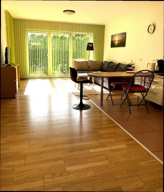 a living room with a table and chairs and a couch at Barrierefreie Ferienwohnung in Bad Windsheim