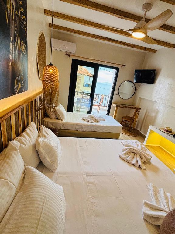 a hotel room with two beds and a window at Hotel marmaras in Neos Marmaras