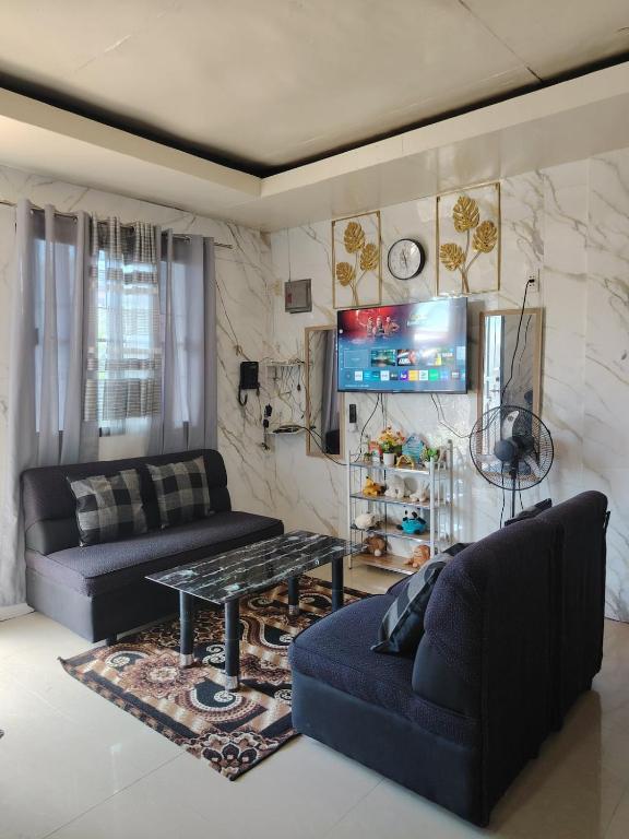 a living room with two couches and a table at PrincessStar in Pagadian