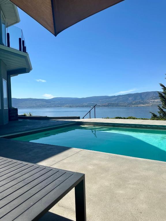 a swimming pool with a view of the water at Lakeview Bed and Breakfast in Kelowna