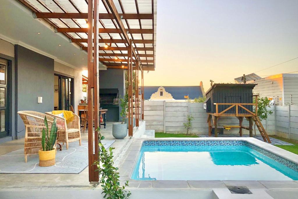 a swimming pool in the backyard of a house at Cape Winelands Mountain View Getaway in Dalsig