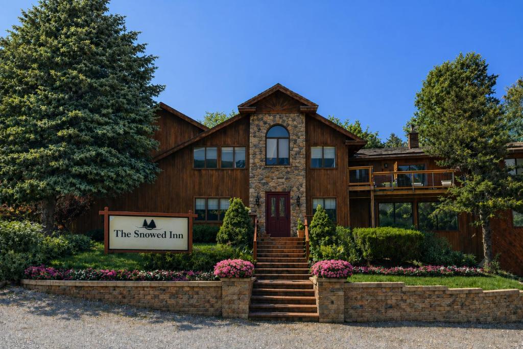 a large house with a sign in front of it at The Snowed Inn in Killington