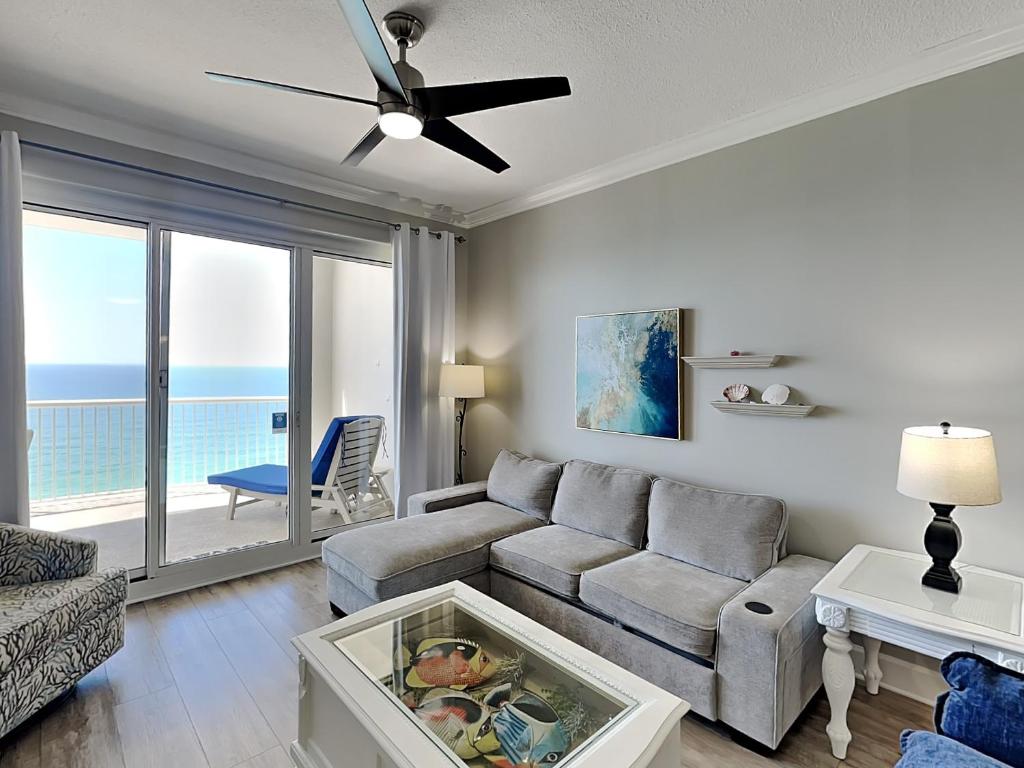a living room with a couch and a ceiling fan at Island Royale Penthouse #405 in Gulf Shores